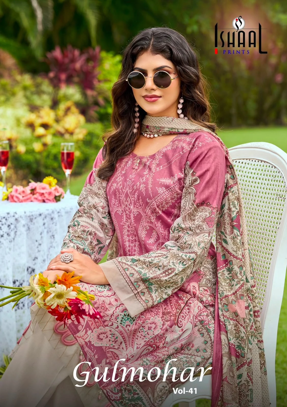Ishaal Prints Gulmohar Vol 41 pink printed salwar suit with floral patterns and matching dupatta worn by a model in a garden setting. - Pakistani Suit Design