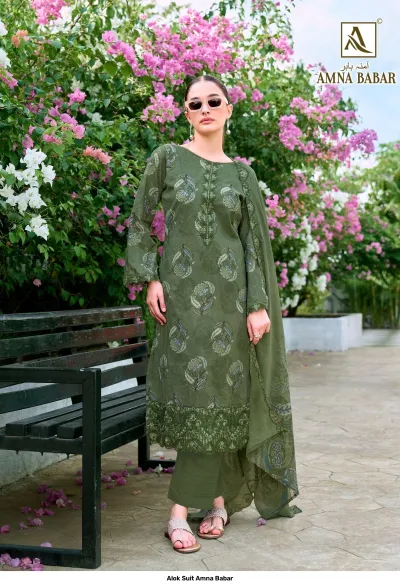 Alok Suit Amna Babar: Model wearing an olive green salwar suit with floral prints and thread work embroidery on the hem.