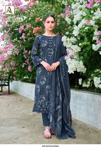 Alok Suit Amna Babar: Model wearing a dark grey salwar suit with floral prints and ornate thread embroidery on the neckline and hem.