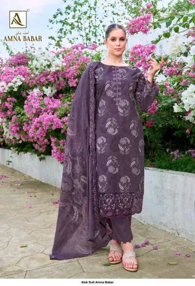 Alok Suit Amna Babar: Model wearing a deep purple salwar suit with floral prints and intricate thread work embroidery on the hem.