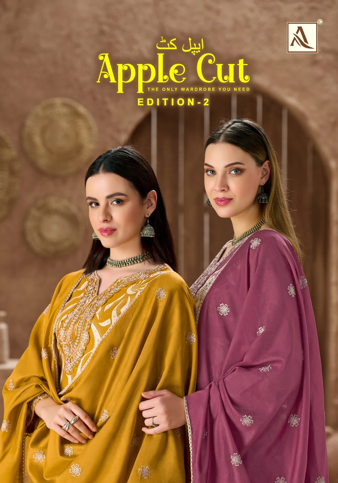 Alok Suit Apple Cut Edition 2 catalog cover showing two women in mustard and purple salwar suits with embroidery.