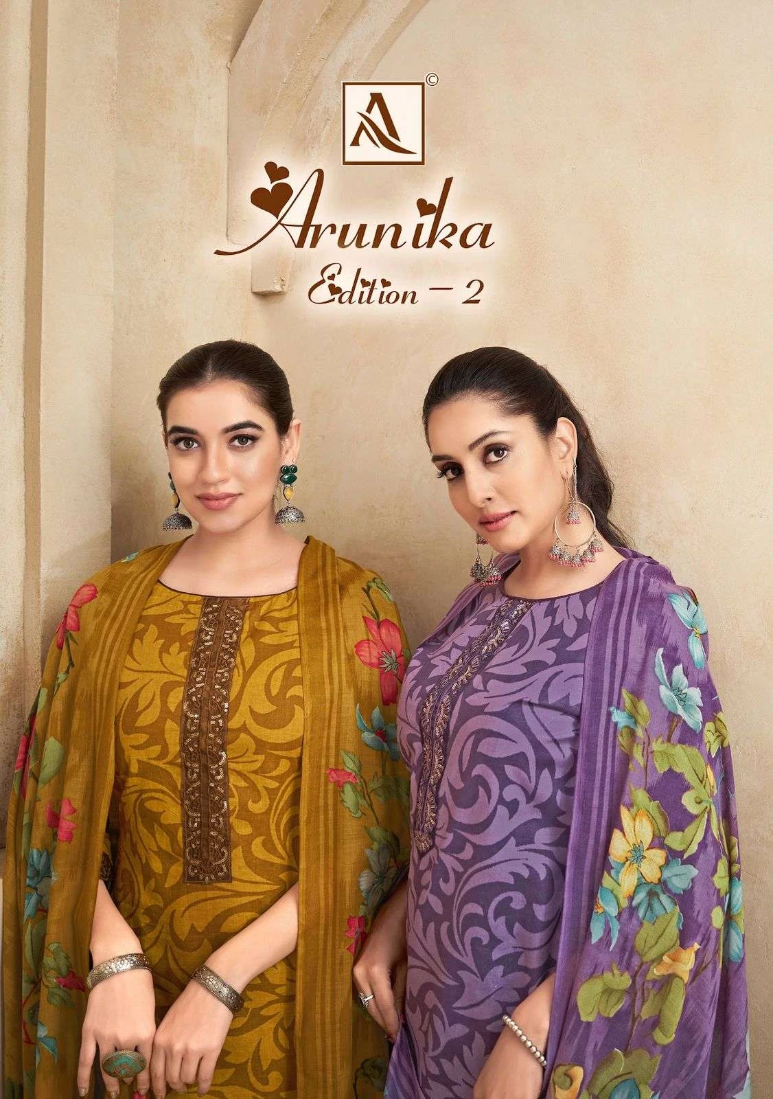 Alok Suit Arunika Edition 2 catalog cover featuring models in various patterned salwar suits with floral dupattas.