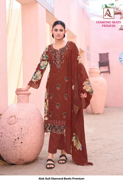 Alok Suit Diamond Beats Premium: Deep rust-colored salwar suit featuring floral print dupatta and thread work embroidery.