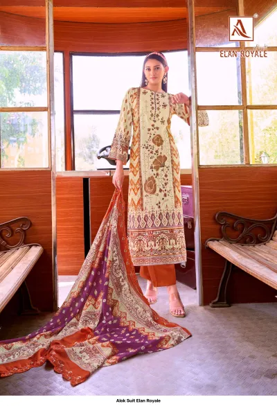 Alok Suit Elan Royale: Model wearing a beige and orange printed straight-cut salwar suit with floral thread work and a contrast orange dupatta.