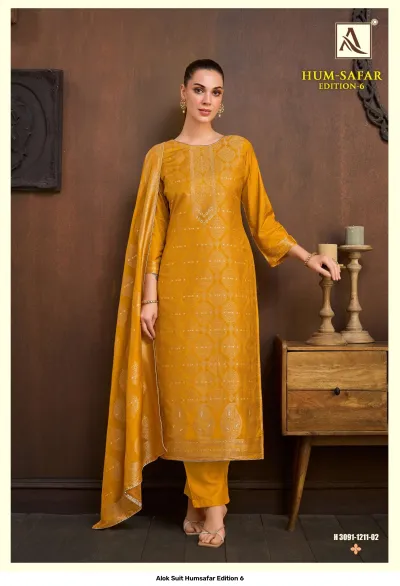 Alok Suit Humsafar Edition 6: Mustard yellow salwar suit with gold zari work, straight-cut kurti, matching pants, and a matching printed dupatta.