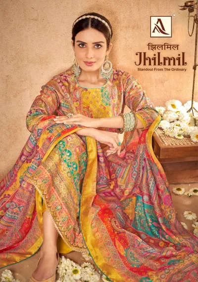 Alok Suit Jhilmil: A model wearing a yellow and multi-colored printed salwar suit with ornate traditional patterns and matching patterned dupatta.