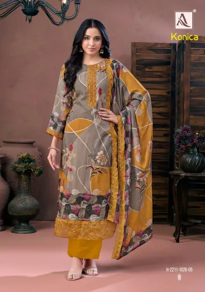 Alok Suit Konica yellow and grey printed salwar suit featuring floral patterns, thread work, and zari embroidery on the neck and hem.