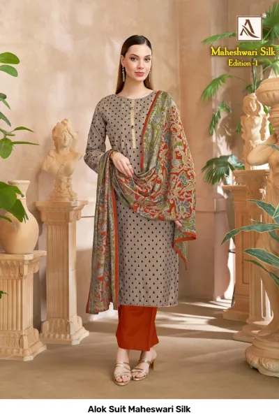Alok Suit Maheswari Silk: A grey kurti with black triangle patterns, terracotta pants, and a floral printed dupatta.