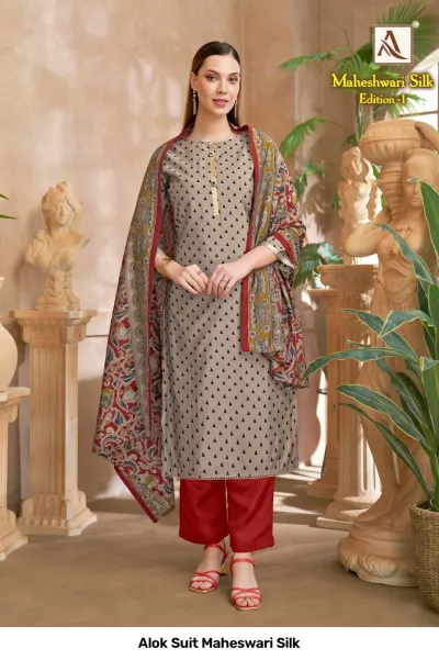 Alok Suit Maheswari Silk: A grey kurti with black triangle patterns, red pants, and a red and green floral printed dupatta.