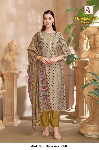 Alok Suit Maheswari Silk: A grey kurti with black triangle patterns, mustard pants, and a mustard floral printed dupatta.