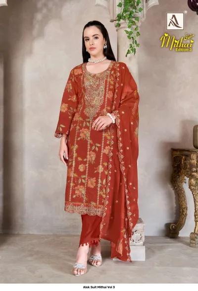 Alok Suit Mithai Vol 3, rust orange salwar suit with floral print, matching dupatta, and intricate gold zari thread work.