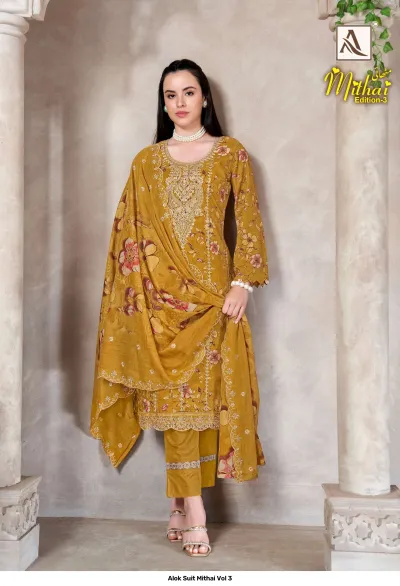 Alok Suit Mithai Vol 3, mustard yellow salwar suit with floral print, matching dupatta, and gold zari thread embroidery.