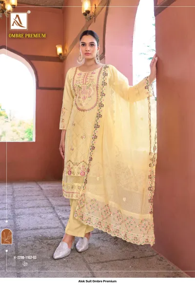 Alok Suit Ombre Premium: Yellow salwar suit with floral embroidery, decorative thread work, and a matching dupatta.