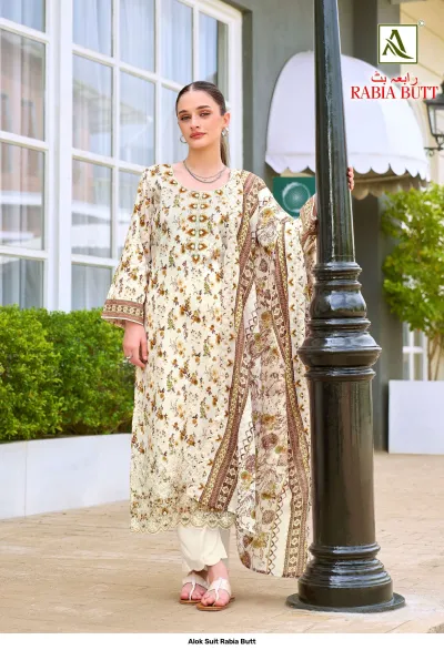 Alok Suit Rabia Butt: Cream-colored printed salwar suit with floral patterns, featuring embroidery work on the neckline and hemline.