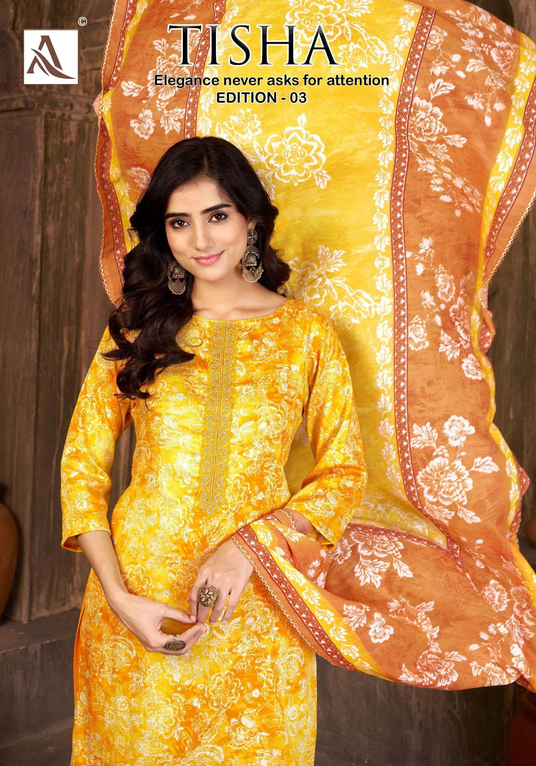 Alok Suit Tisha Edition 3: Woman wearing a yellow floral printed salwar suit with thread work on the neckline.