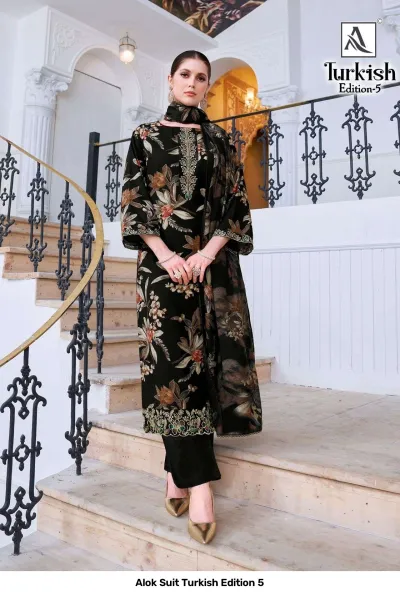 Alok Suit Turkish Edition 5: Model wearing a black salwar suit with a bronze floral print and thread work embroidery on the hem.