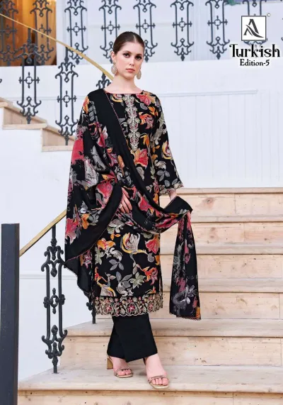 Alok Suit Turkish Edition 5: Model wearing a black salwar suit with a multi-colored floral print and thread work embroidery on the hem.