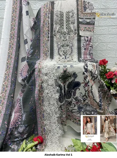 Alzohaib Karima Vol 1: A display of a cream salwar suit dress material featuring floral prints, dark grey accents, and white lace embellishments on the neckline.
