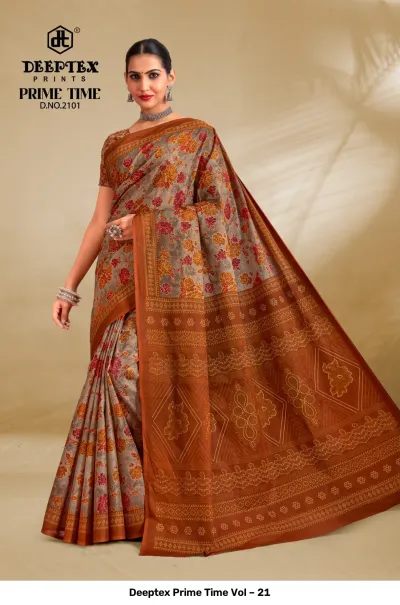 Deeptex Prime Time Vol – 21 grey and burnt orange printed cotton saree with a floral pattern and a wide detailed border.