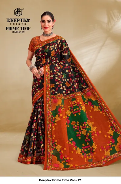 Deeptex Prime Time Vol – 21 black, orange, and green printed cotton saree with a large floral pallu and leaf motifs.