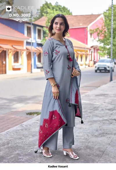 Kadlee Vasant Vol 3002, grey salwar suit with floral thread work, tassels, and a color-blocked floral dupatta, worn outdoors.