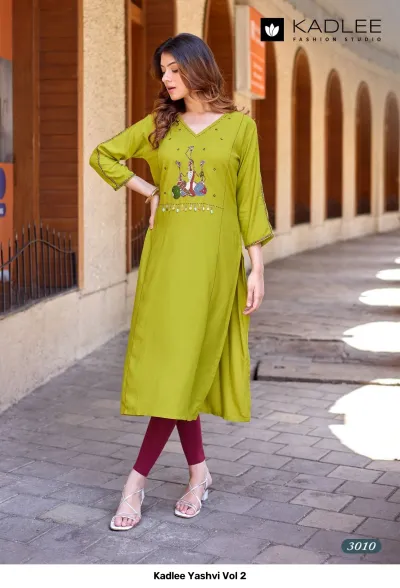 Kadlee Yashvi Vol 2: Lime green straight cut kurti with themed thread work embroidery and decorative hanging details on the chest.