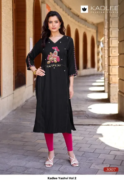 Kadlee Yashvi Vol 2: Black straight cut kurti with themed thread work embroidery and decorative hanging details on the chest.