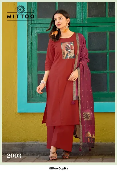Mittoo Gopika: Dark green kurti and palazzo set with a butterfly print mirror work chest patch and a printed, light green dupatta.