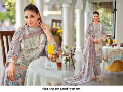 Riaz Arts Bin Saeed Premium grey and orange floral printed salwar suit with thread work embroidery and matching dupatta.
