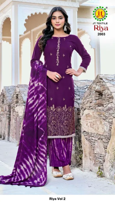 Riya Vol 2: Purple kurti with gold thread work embroidery, matching tie-dye palazzo pants, and a tie-dye dupatta in a stone background.