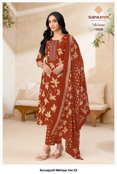 Suryajyoti Nikhaar Vol 15, orange-brown printed cotton salwar suit with leaf pattern, neck thread work, dupatta, and matching printed pants.