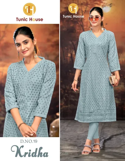 Tunic House Kridha Anarkali: Light blue kurti with all-over embroidered patterns, V-neck, and subtle sequin embellishments, worn with matching leggings.