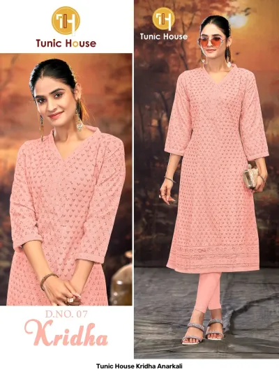 Tunic House Kridha Anarkali: Peach kurti featuring detailed thread work and sequin embellishments, V-neck, three-quarter sleeves, paired with matching leggings.