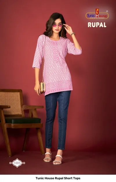Tunic House Rupal Short Tops 1005: A model wears a pink printed cotton kurti top paired with blue jeans.