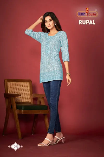 Tunic House Rupal Short Tops 1006: A model wears a light blue printed cotton kurti top paired with blue jeans.