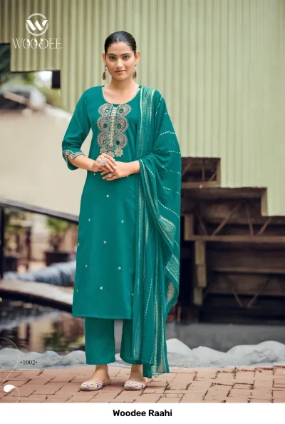 Woodee Raahi: Teal salwar suit with mirror work on the neck, straight-cut pants, and a matching dupatta with zari work borders.