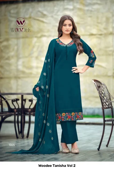 Woodee Tanisha Vol 2 dark teal salwar suit with floral embroidery on the neckline, sleeves, and hem, plus a matching dupatta and pants.