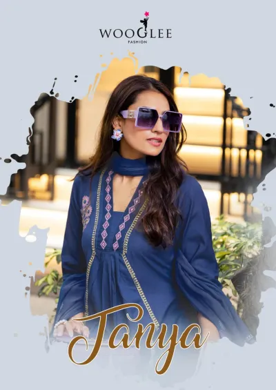 Wooglee Tanya: A dark blue salwar suit with thread work on the neckline and floral-patterned hem, styled with a matching dupatta.