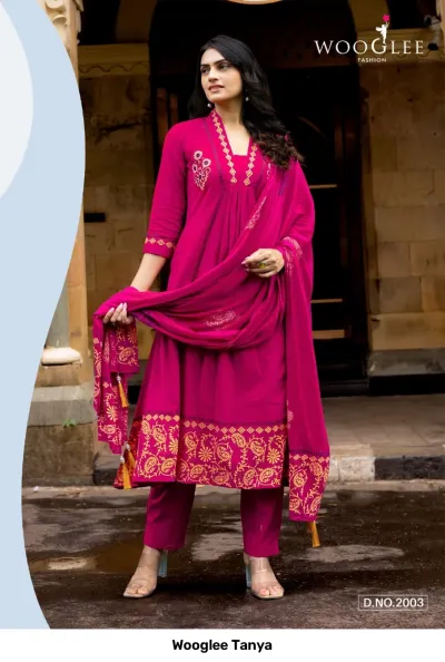 Wooglee Tanya D.No.2003: A bright pink salwar suit with intricate thread work on the bodice, printed borders, and a matching dupatta.
