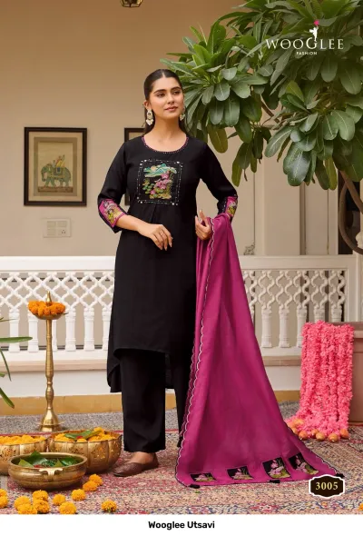 Wooglee Utsavi 3005: Black solid salwar suit with high-low kurti, colorful thread work embroidery on chest, and magenta dupatta.