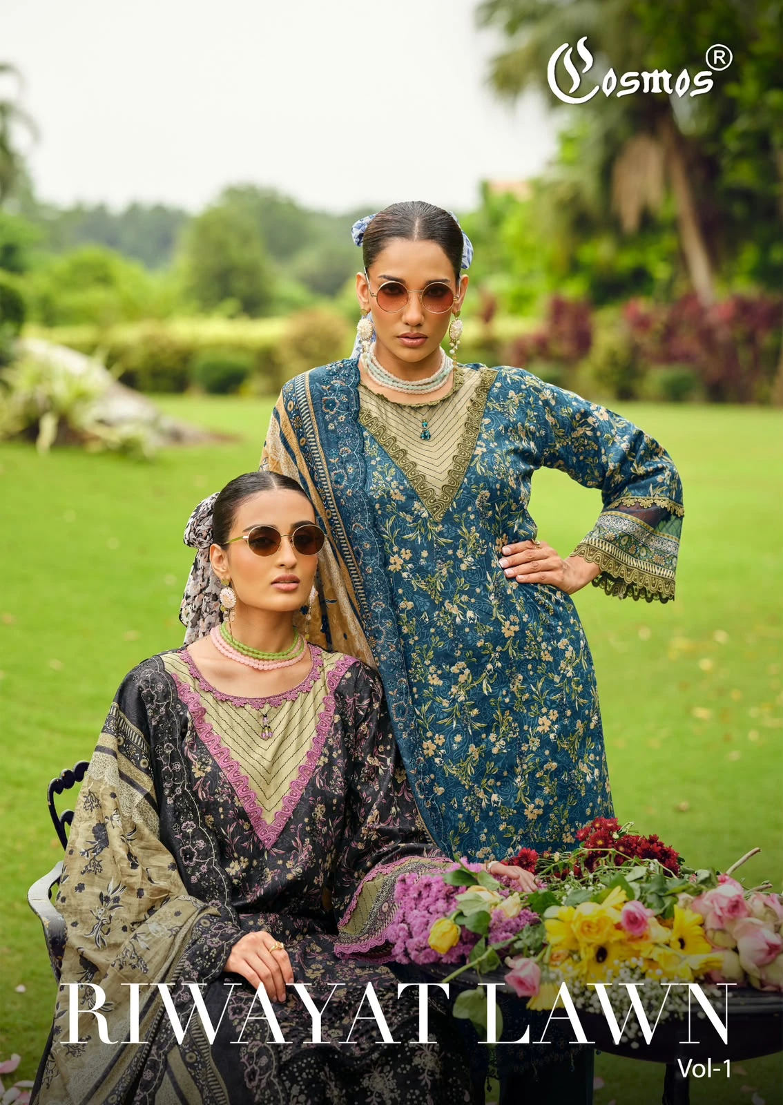 Cosmos Riwayat Vol 1: Catalog cover featuring two models wearing printed salwar suits with intricate thread work embellishments in a garden setting.