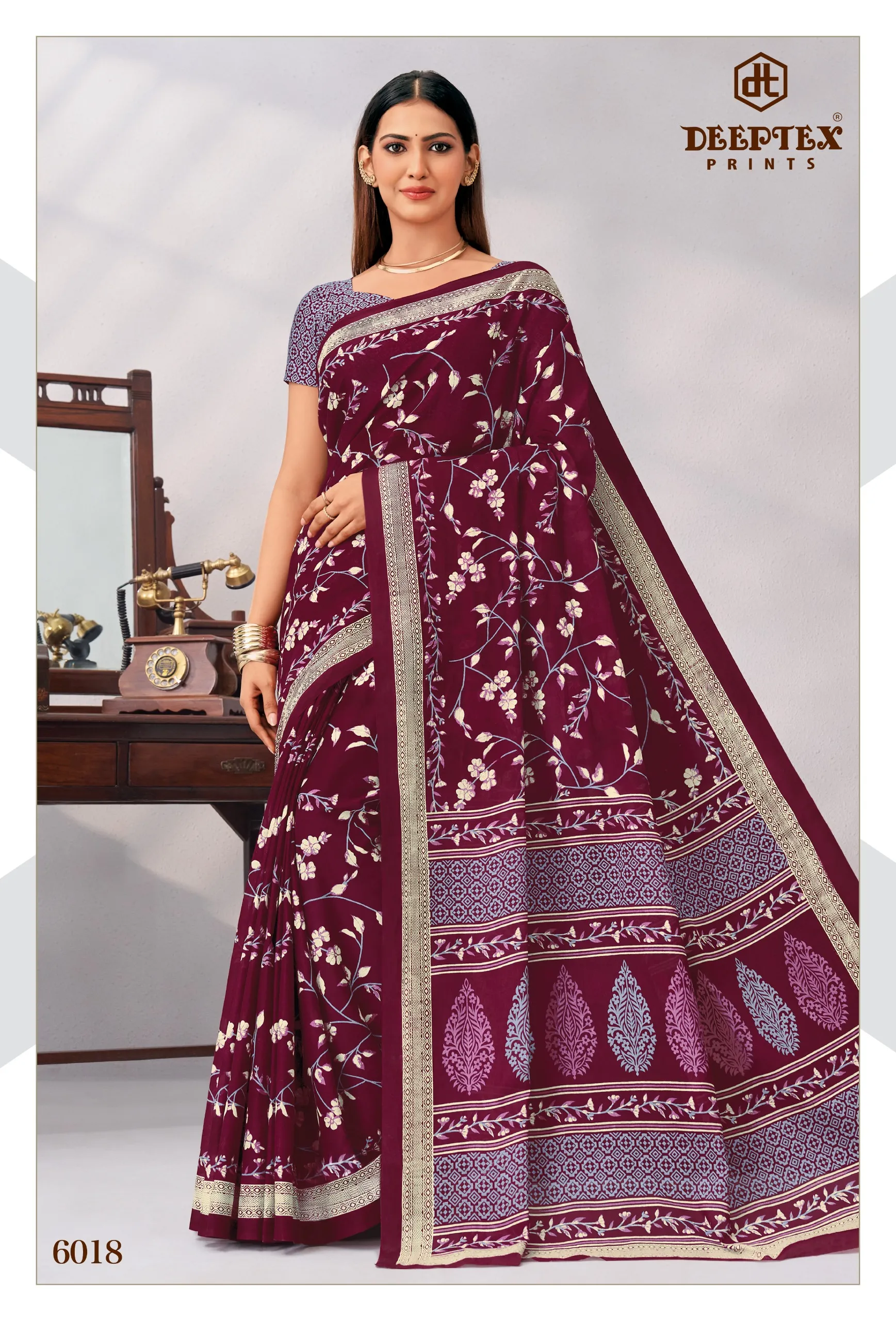 Deeptex Mother India Vol 60, maroon floral printed saree with contrasting border and matching blouse.