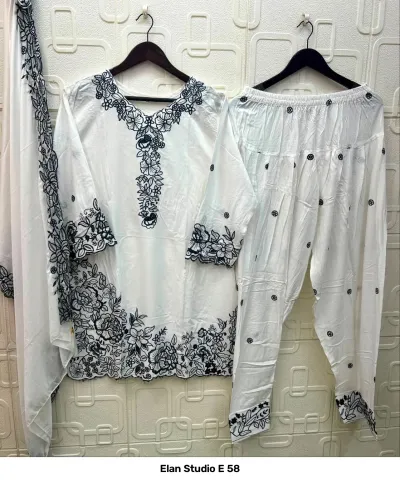 Elan Studio E 58: White rayon salwar suit set featuring dark blue floral thread work embroidery on the kurti, salwar, and matching dupatta.