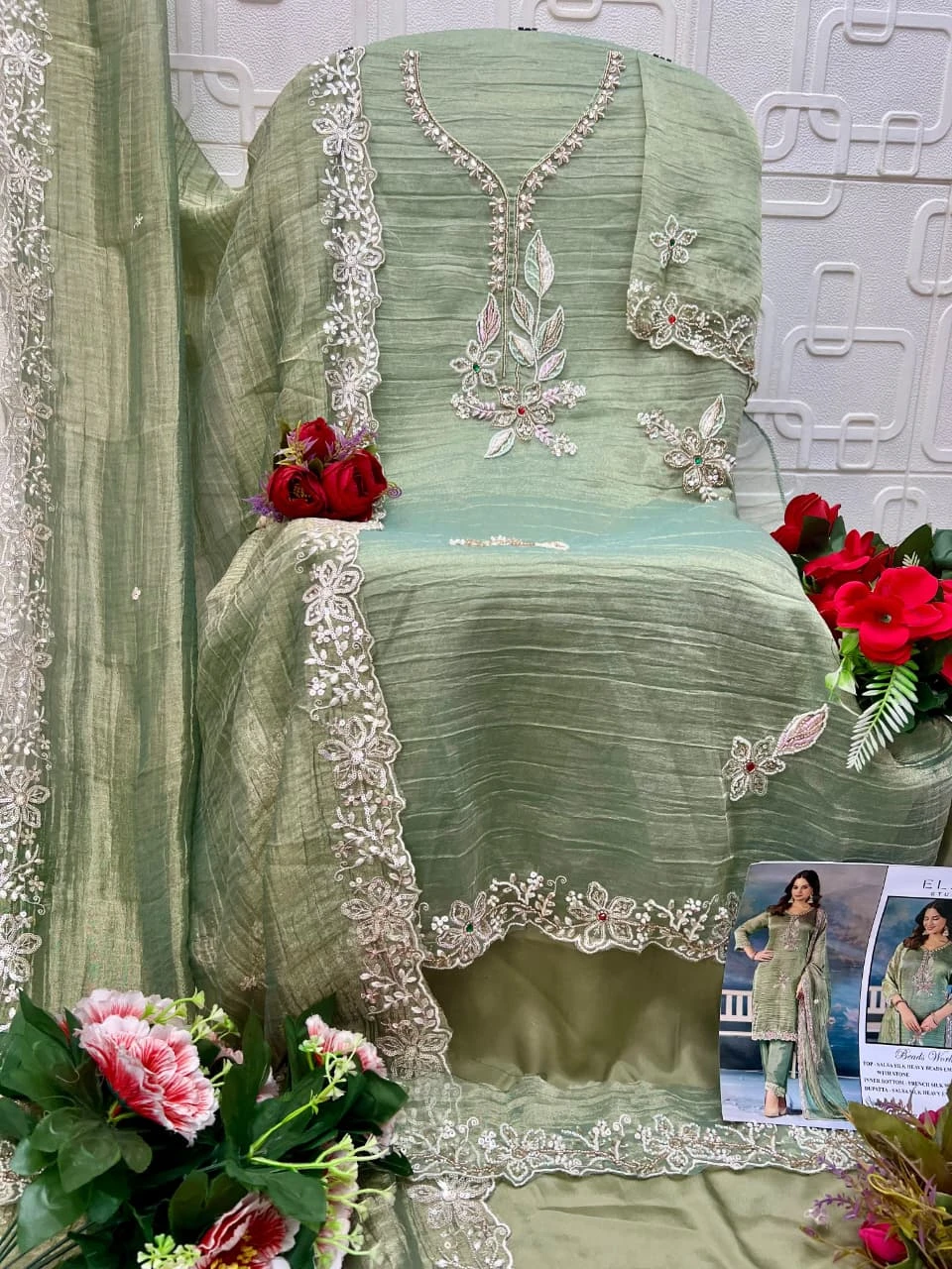 Elan Studio E 64: Sage green salwar suit, silk fabric, featuring heavy bead embroidery, stone embellishments, and a matching dupatta with embroidered borders.