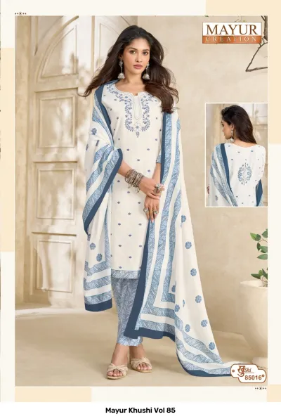 Mayur Khushi Vol 85 white salwar suit with blue floral patterns, an embroidered neckline, printed pants, and a blue-bordered patterned dupatta.