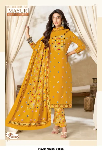 Mayur Khushi Vol 85 mustard yellow salwar suit with circular patterns, contrast embroidered neckline, printed pants, and a patterned dupatta.