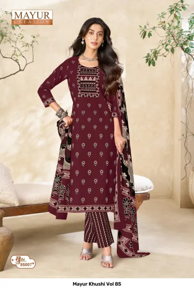 Mayur Khushi Vol 85 maroon salwar suit with small floral motifs, embroidered neckline, striped pants, and a printed contrast dupatta.