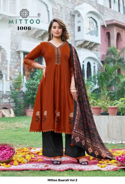 Mittoo Baarati Vol 2: Rust orange kurti with floral print hem and embroidery, paired with black palazzo pants and a patterned dupatta.