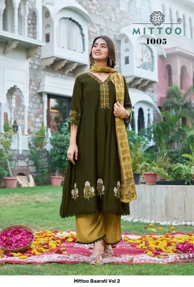 Mittoo Baarati Vol 2: Olive green kurti with floral print hem and embroidery, paired with mustard yellow palazzo pants and a patterned dupatta.