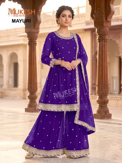 Mukesh Mayuri: A royal blue sharara salwar suit featuring gold zari work and minimal embellishment on the kurta and hem.